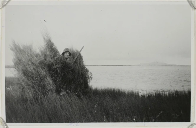 Duck shooter R M Royds looks out from his mai mai on Invercargill Estuary