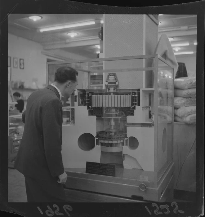 An unidentified man looks at a model of a Roxburg Generator in a display case