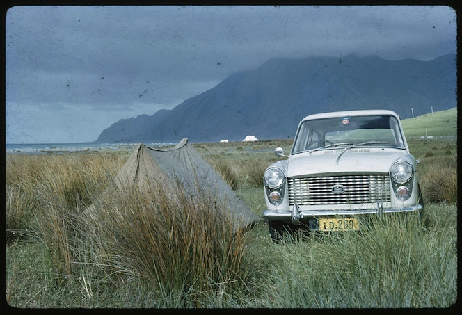 Austin A40 automobile parked beside a small tent, Wairarapa