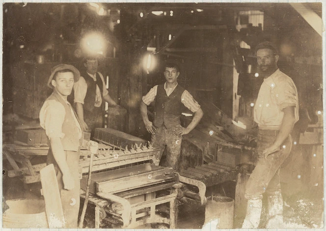 Photograph - Four workers at the brick making machine inside Enoch Tonk's Brick Factory