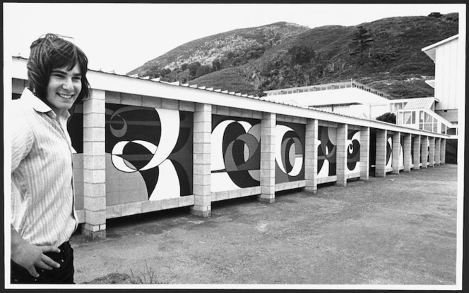 Nigel Swinn standing beside a mural at Wainuiomata College