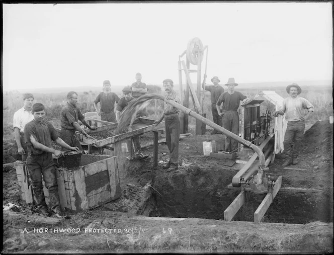 Men washing soil to find kauri gum, Northland