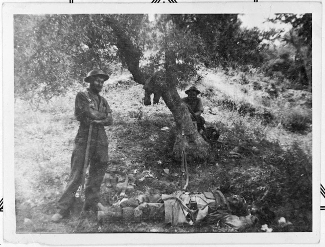 World War II soldiers from New Zealand with dead German paratrooper, Crete, during World War II
