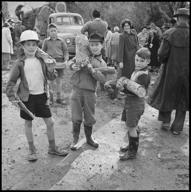 Three boys holding pieces of a redwood tree, Pine Avenue, Upper Hutt