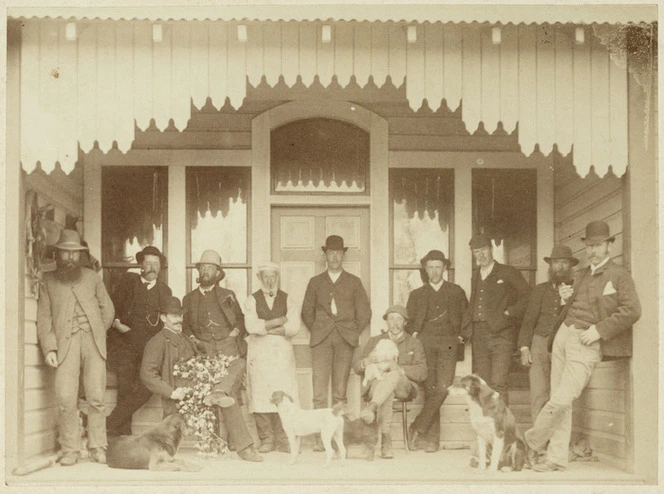 Group of men and dogs on a veranda