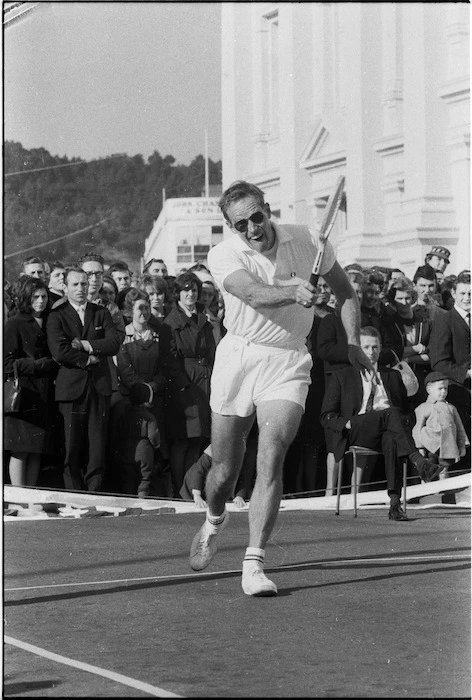 Charlton Heston playing tennis, Mercer Street, Wellington