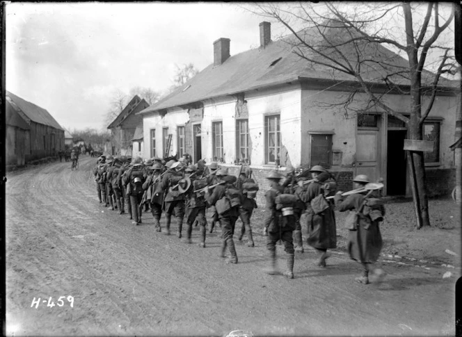 A New Zealand working party walking through Courcelles, France, World War I