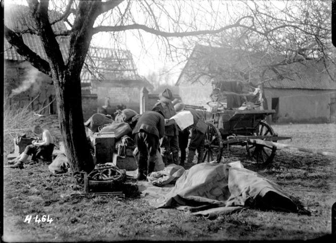 Soldiers working in the wagon lines catch up with the news, France