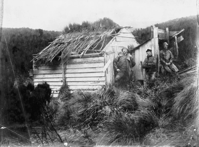 Hut on Campbell Island with three unidentified men