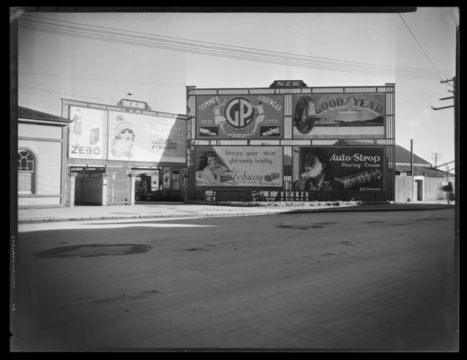 Billboards advertising various consumer items, outside New Zealand Railways yards, Invercargill Railway Station