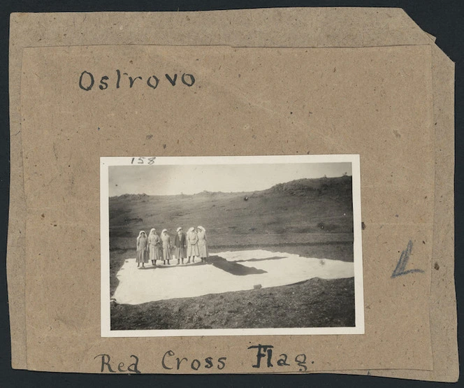 Medical staff standing on a giant Red Cross flag at the main hospital camp of the 7th Medical Unit of the Scottish Women's Hospitals for Foreign Service, at Ostrovo, Macedonia, Serbia, during World War I
