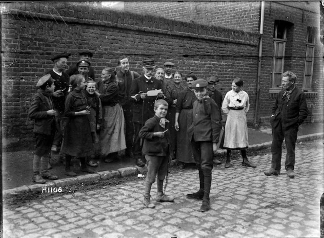 The town crier reads news of Allied victories in Solesmes, France, World War I