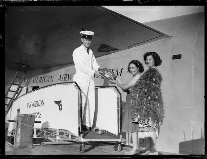 Pan American Airways crew member with Maori women