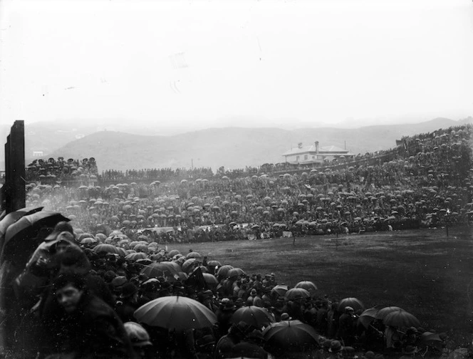 Crowd of rugby spectators in the rain at Athletic Park, Wellington