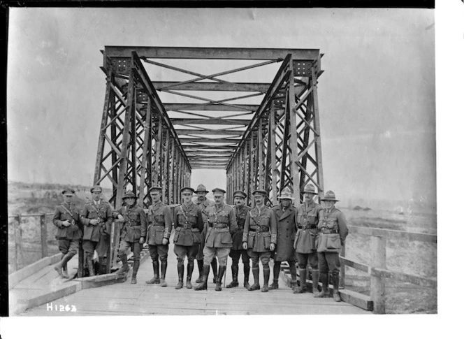 New Zealand engineers with the iron bridge that they designed and built