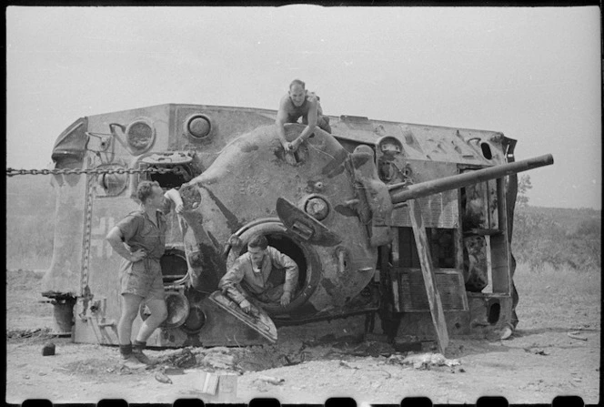 New Zealanders working on a recaptured tank, World War II, Italy - Photograph taken by George Kaye