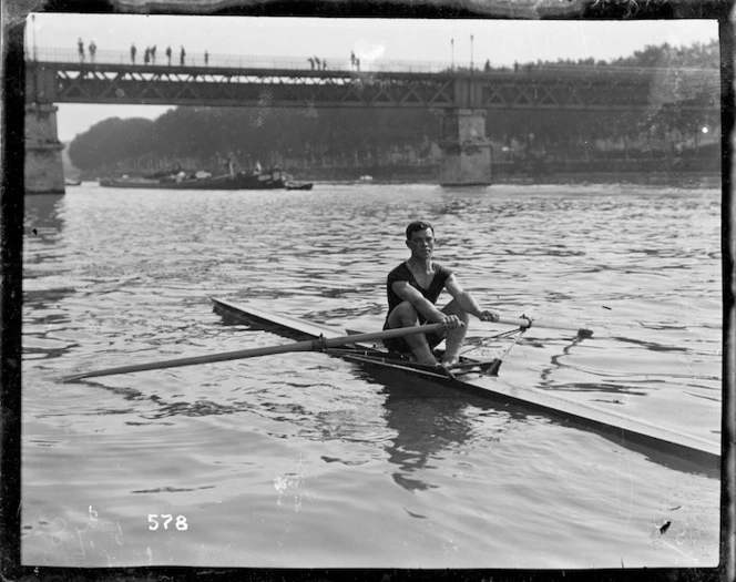 A single sculler approaching a bridge at the Royal Henley Peace Regatta, England