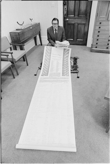 Acting Parliamentary Speaker, Jonathan Hunt, with the cloak, petition, and Memorial of Right presented to him by the Te Roopu Ote Matakite (Maori Land March 1975)
