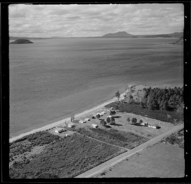 View of the settlement of Tauranga Taupo with houses on Waitetoko Road to Motutaiko Island beyond, eastern side of Lake Taupo