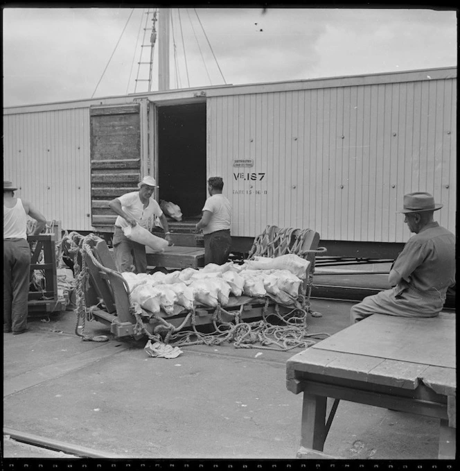 Men unloading lamb from a railway wagon at Opua wharf