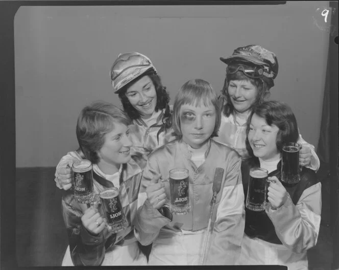 Woman Jockeys drinking Lion beer