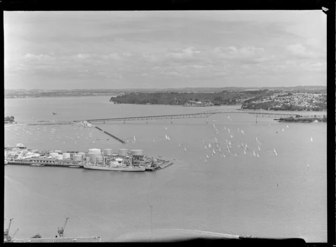 Auckland Harbour Bridge and 'tank farm' with a flotilla of yachts