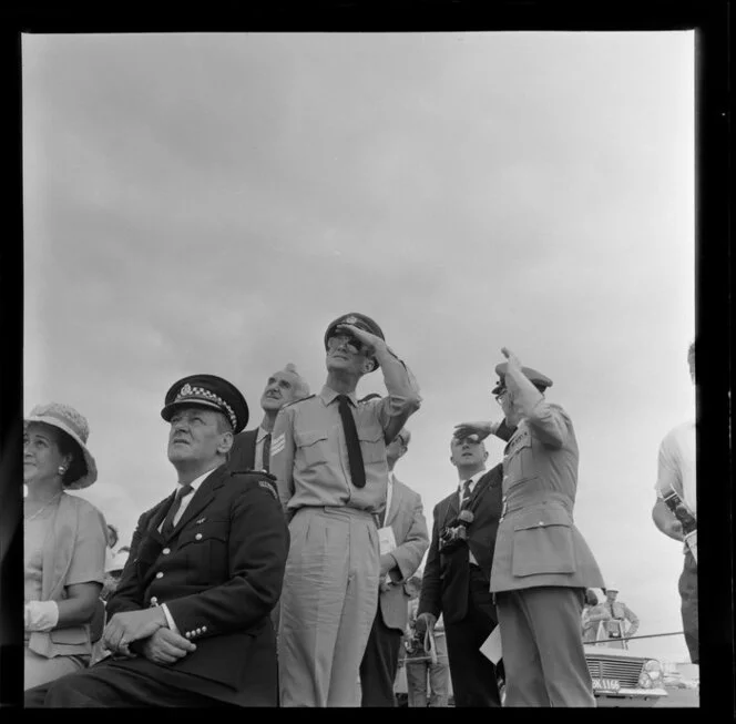 Spectators gazing at the sky at the Royal New Zealand Aero Club pageant, Ardmore