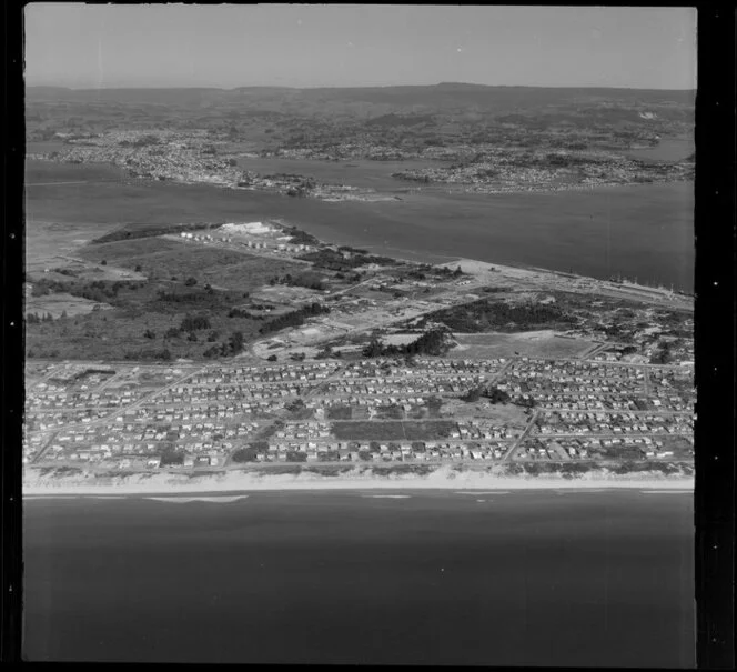 Upper Tauranga Harbour, with site of fertilizer works prominent, surf beach in foreground