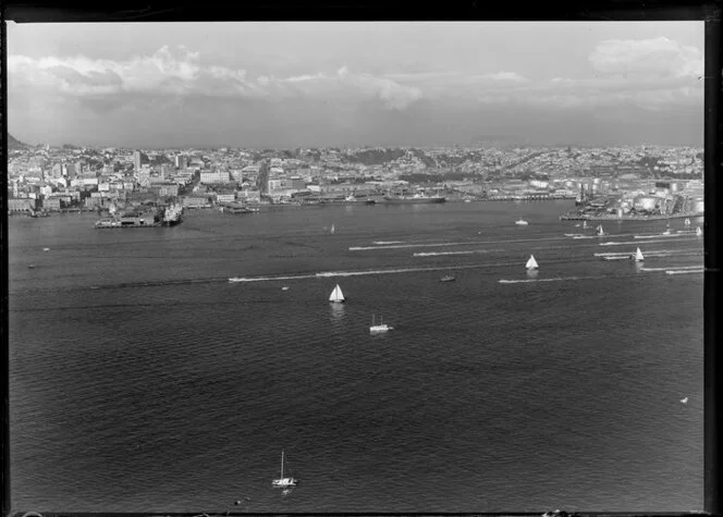 Power boat races on Waitemata Harbour, Auckland, including a view of the waterfront, wharves, and city buildings