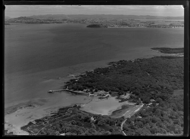 Main wharf area, Rangitoto Island, with baches and coastal road on souuthern shore