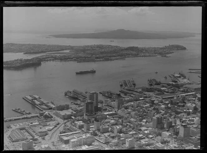 Auckland City and wharves, including Rangitoto Island in the background