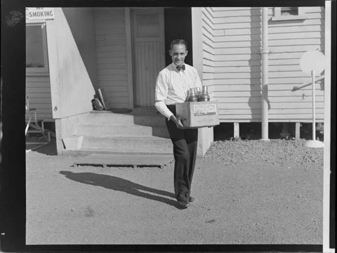 Airline steward F Bennett carrying supplies to a Dakota aircraft