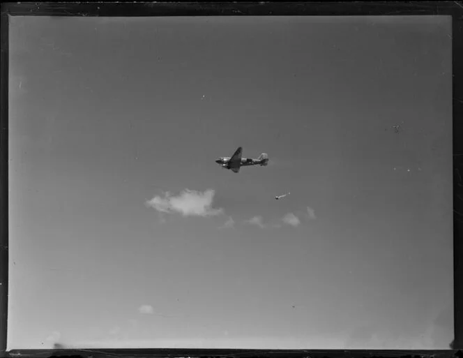 Royal New Zealand Air Force Dakota aircraft dropping supplies by paraachute