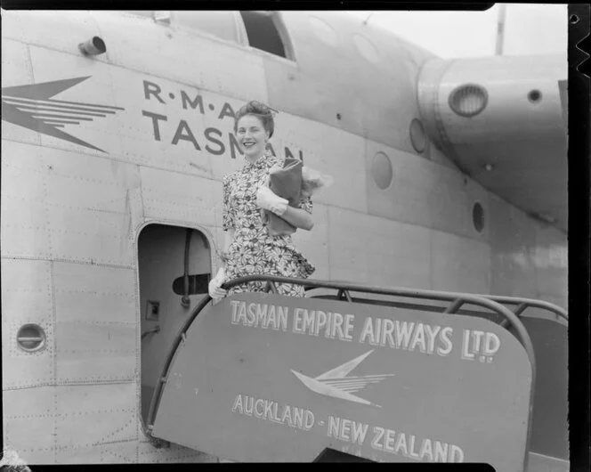 Mary Wootton (Miss New Zealand) outside a Tasman Empire Airways Ltd aeroplane