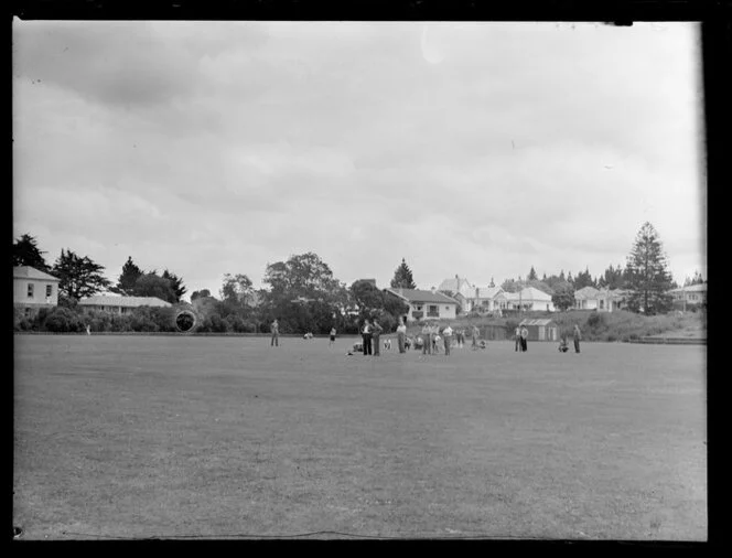 Auckland Aero Club members watching V Pepperell's model aeroplane in flight