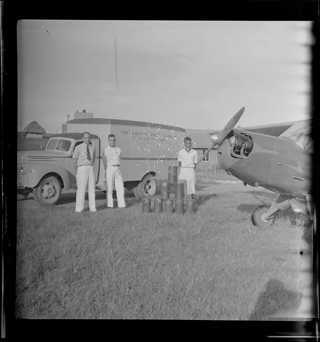 Arrival of ice cream canisters on a Taylor aircraft at Nadi Airport, Fiji, T French standing on the left