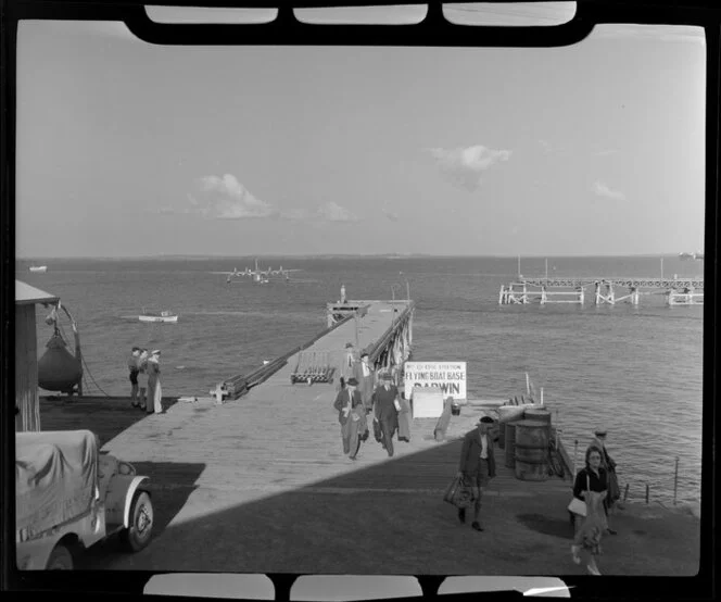 Passengers alighting on dock at Flying Boat Base, Darwin