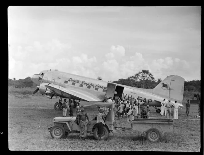 Crowd, awaiting the arrival of the Qantas Empire Airways' DC-3, VH-EAP, airstrip, Kavieng Island, New Ireland, Papua New Guinea