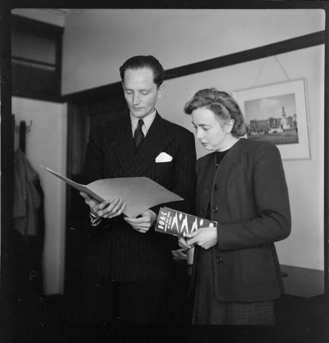 British Overseas Airways Corporation employee Miss Fawcett and an unidentified man perusing documents [Qantas headquarters, Mascot, New South Wales?] Australia