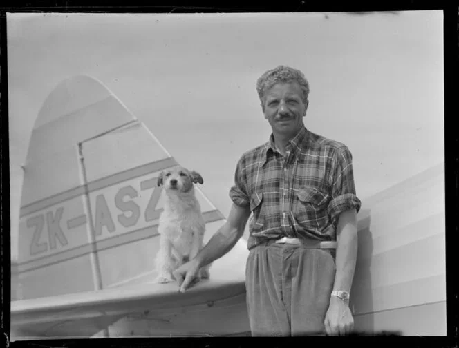 Mr Vic Hunter of Rotorua with dog beside his Fairchild Argus aircraft [Tauranga Aero Club?]