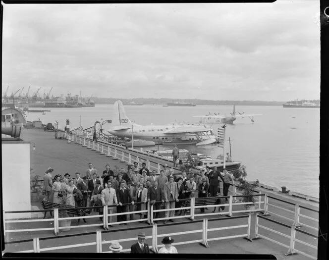 Passengers waiting to board the Tasman Empire Airways Ltd Solent seaplane Aotearoa II ZK-AML, Mechanics Bay, Auckland