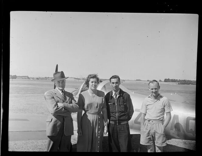 French visitors to the Auckland Aero Club in front of an airplane, Mangere Aerodrome, Manukau City, Auckland Region