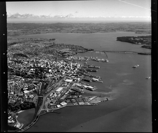 Auckland City looking towards Waitakere City, including Parnell Baths, Port, Railway Station, Harbour Bridge, and Waitemata Harbour