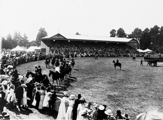 Crowd watching a parade of horses, Masterton showgrounds