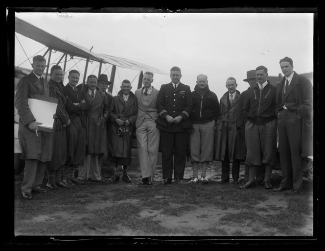 Group portrait with aircraft in background