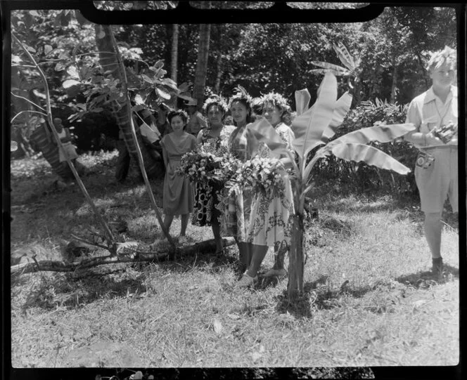 Unidentified local women hold flowers probably to present to guests at a ceremony feast, Tahiti