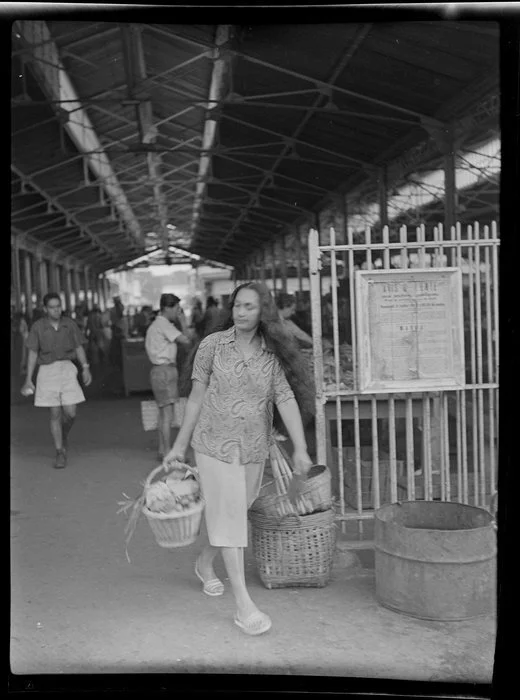 Market scene, woman leaving market with basket of food, Papeete, Tahiti