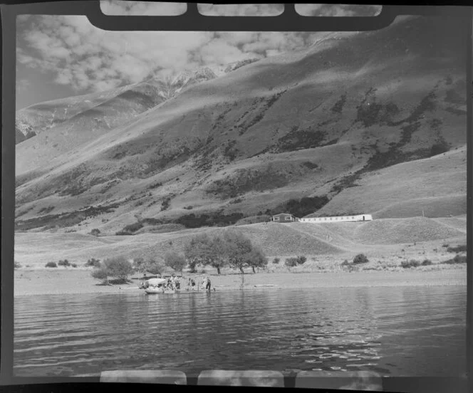 Lake Ohau, Waitaki District, Canterbury Region, showing passengers disembarking from a charter boat; Ohau Lodge in the centre