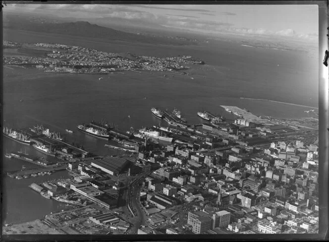 Auckland City and wharves, showing Devonport and Rangitoto Island in the distance