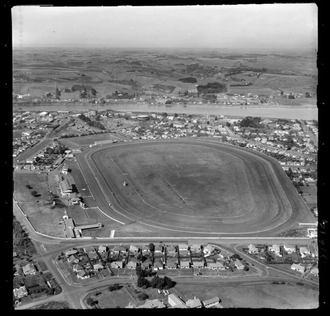 Wanganui, Gonville, closeup of racecourse and Spriggens Park and Jacksons Street with residential housing, with the Whanganui River and farmland beyond